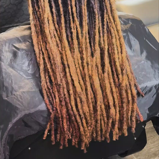 Hydrating locs and natural hair with Loc Libation mist for enhanced moisture.
