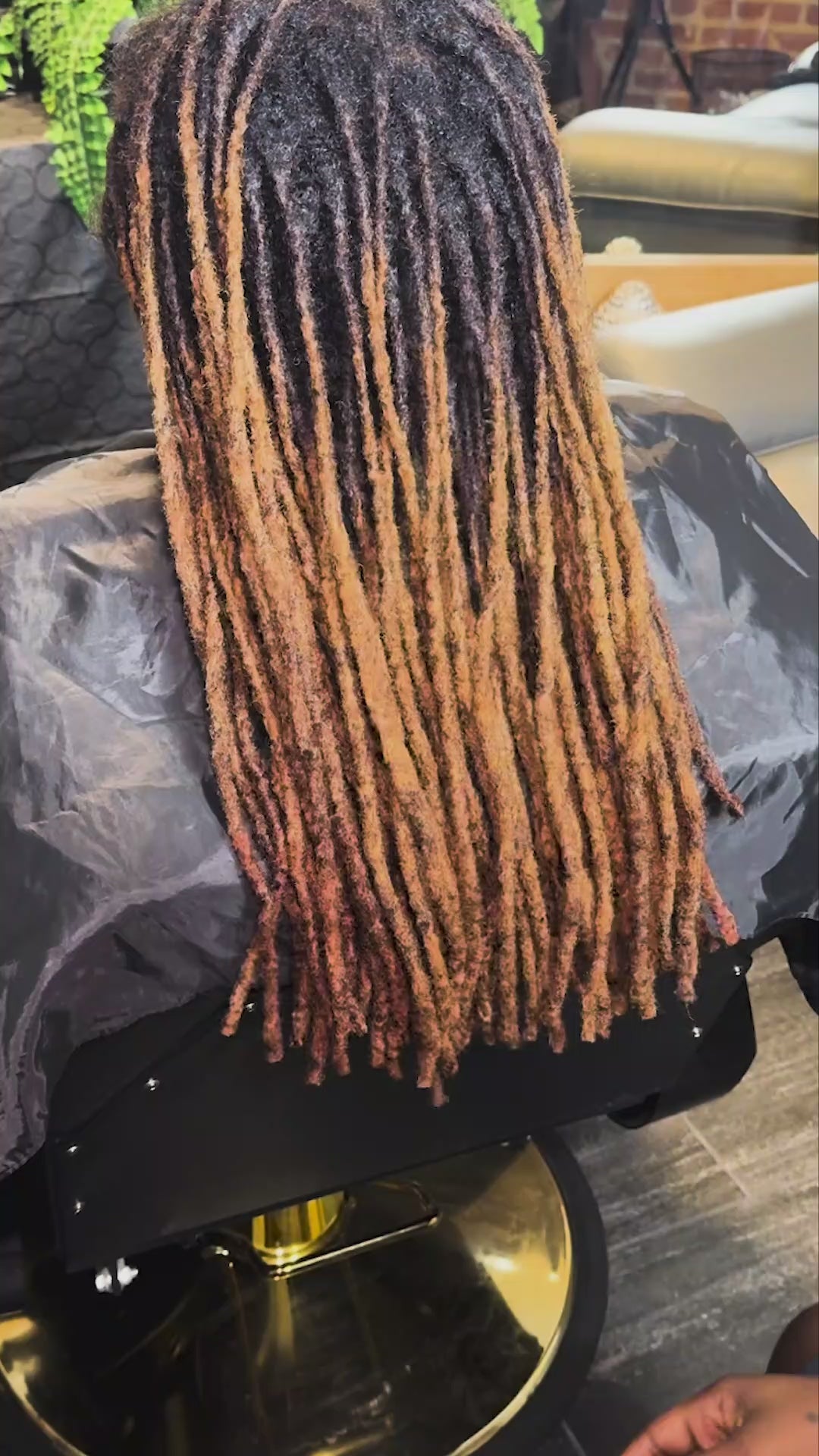 Hydrating locs and natural hair with Loc Libation mist for enhanced moisture.
